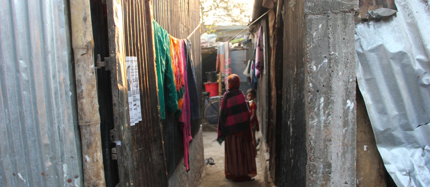  A woman walks through a neighborhood where many garment workers live in Dhaka. Photo credit Bishawjit Das 